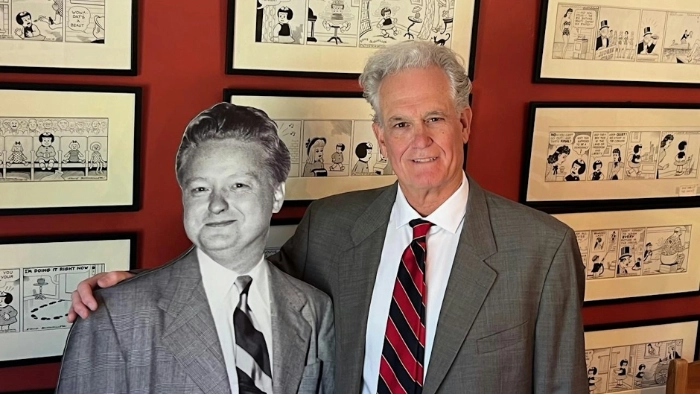 Tom Gammill stands next to Ernie Bushmiller cut out.